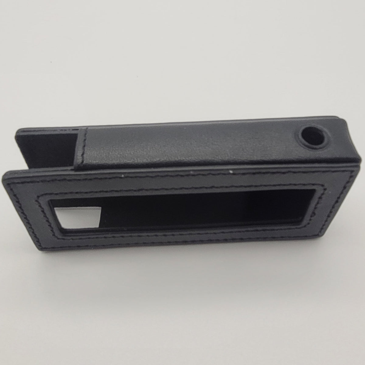 Black rectangular object with a slot on a white background